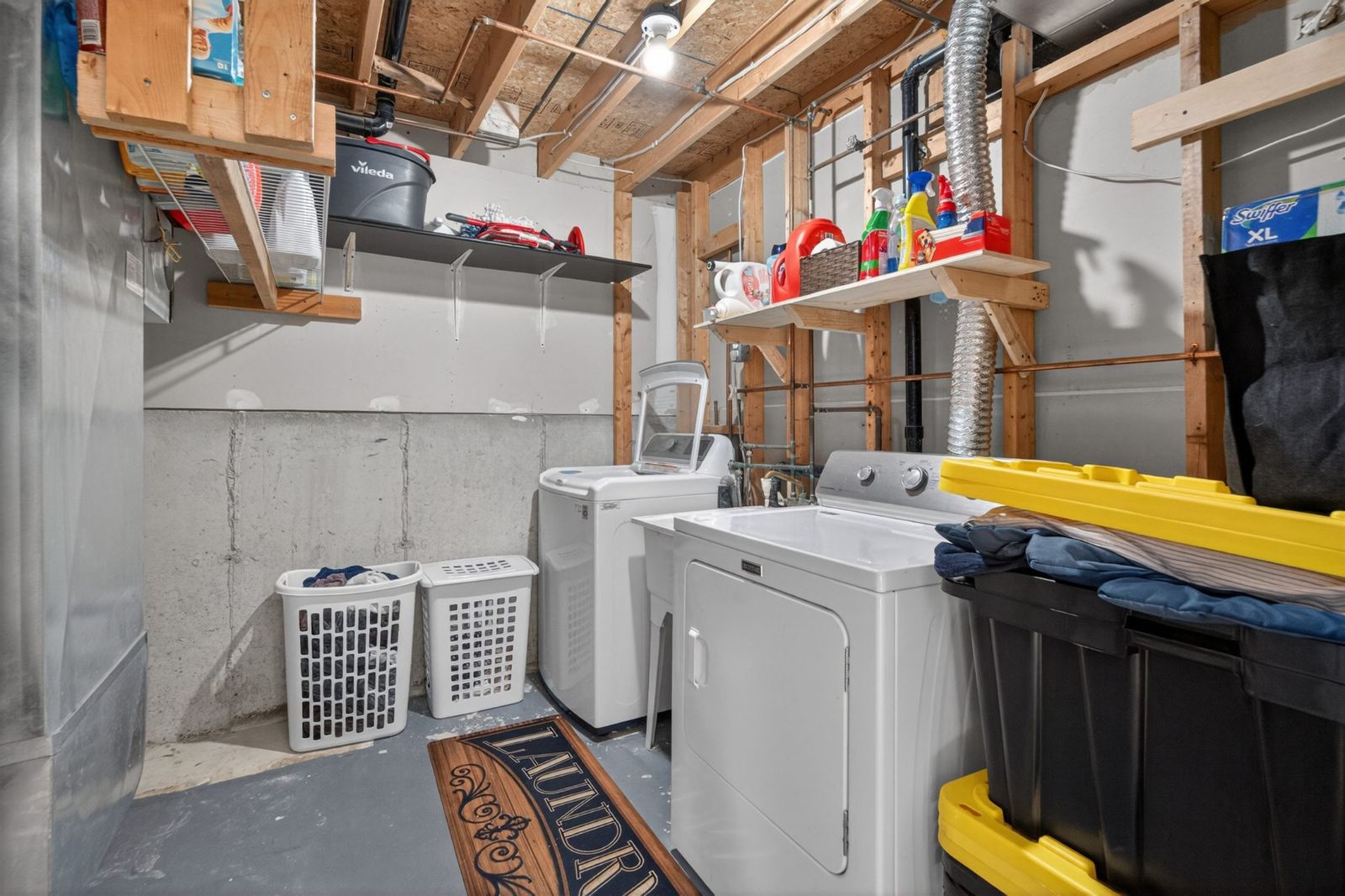 Laundry room with washer, dryer, and utility sink