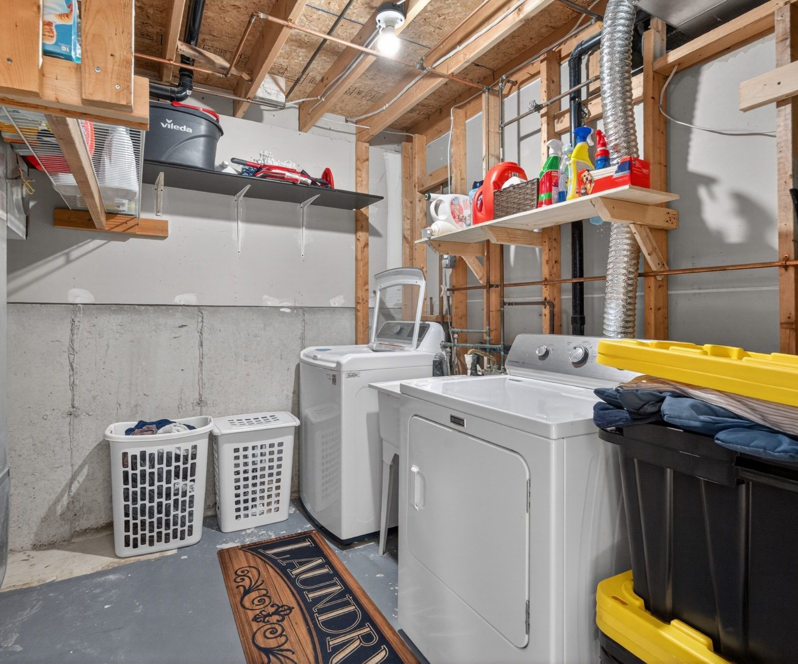 Laundry room with washer, dryer, and utility sink