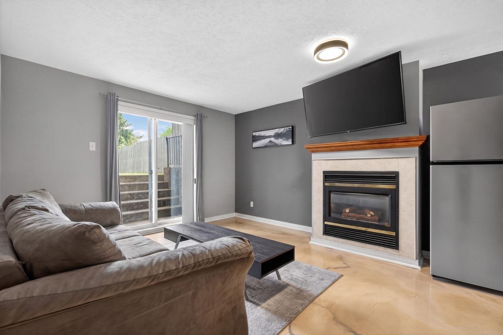 Lower level with gas fireplace and mounted TV