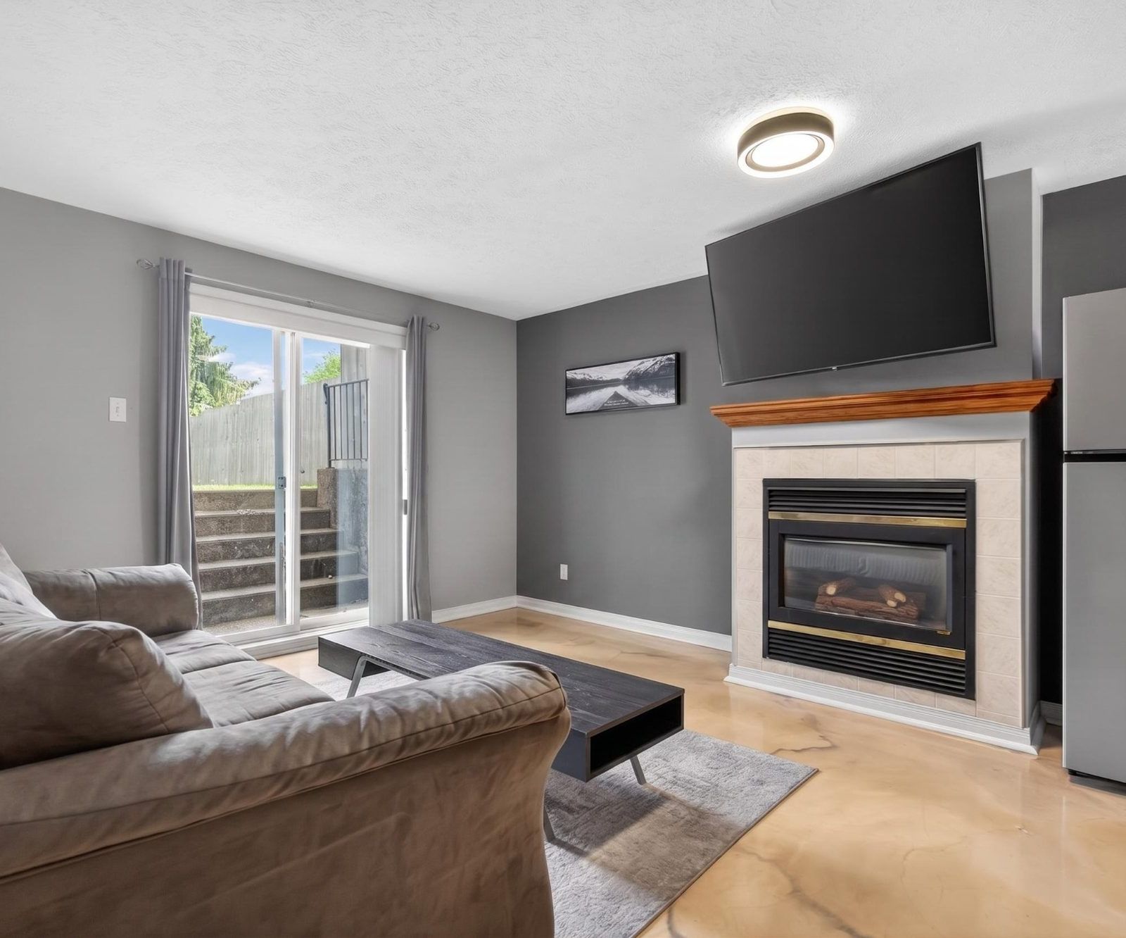 Lower level with gas fireplace and mounted TV
