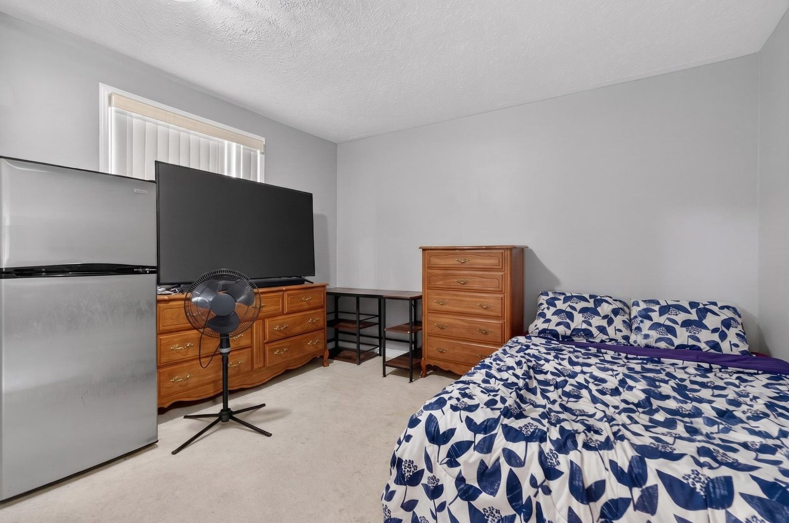 Bedroom with dressers and shelving