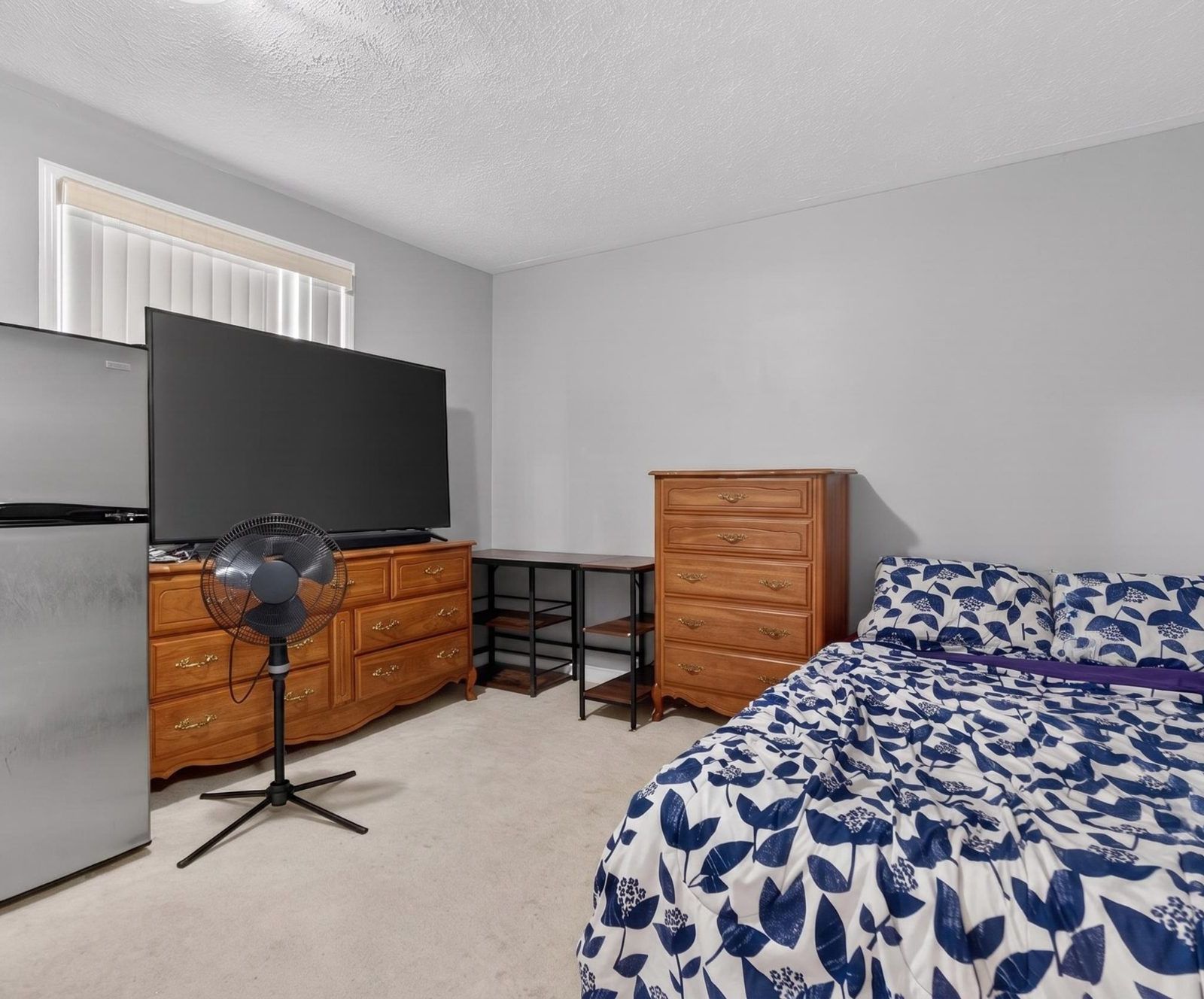 Bedroom with dressers and shelving
