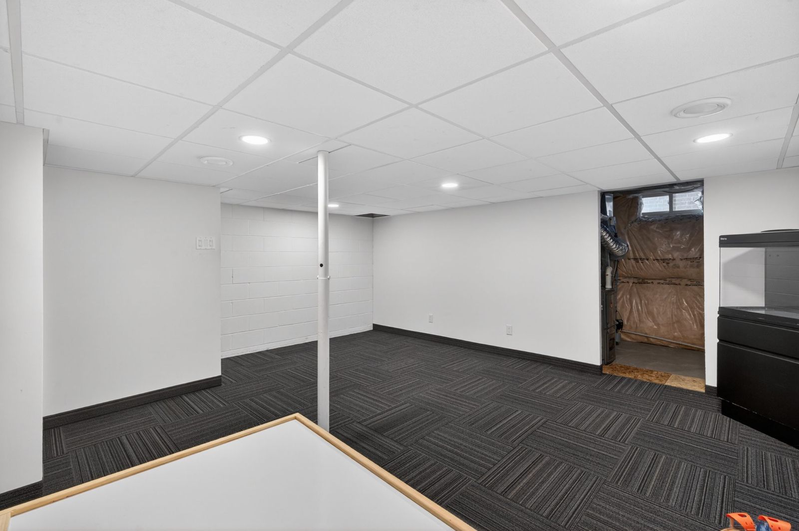 Basement open space with white walls and recessed lighting