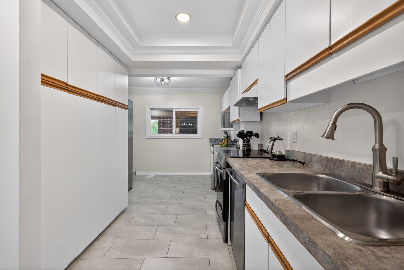 Kitchen - tray ceiling, white cabinets, double sink