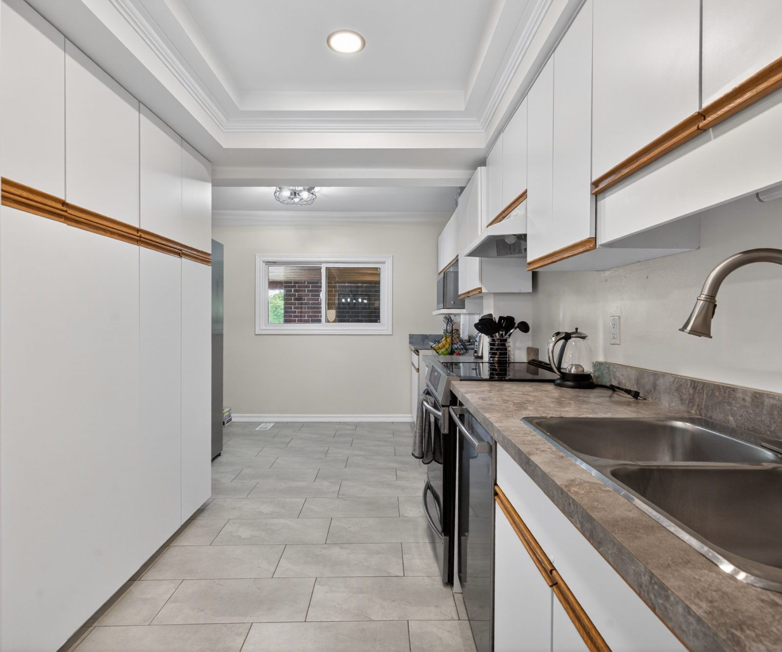 Kitchen - tray ceiling, white cabinets, double sink