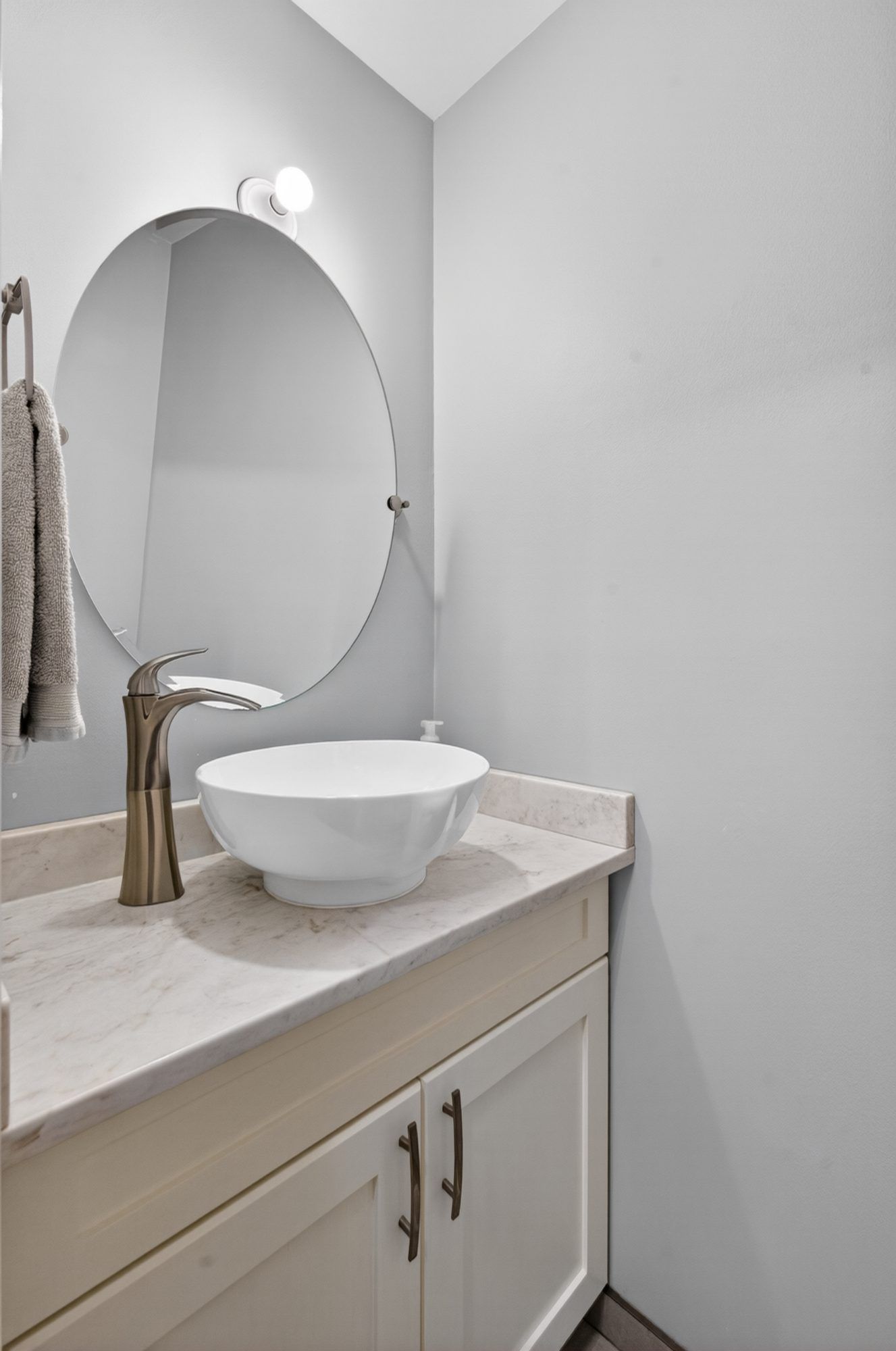 Bathroom vanity with vessel sink and round mirror