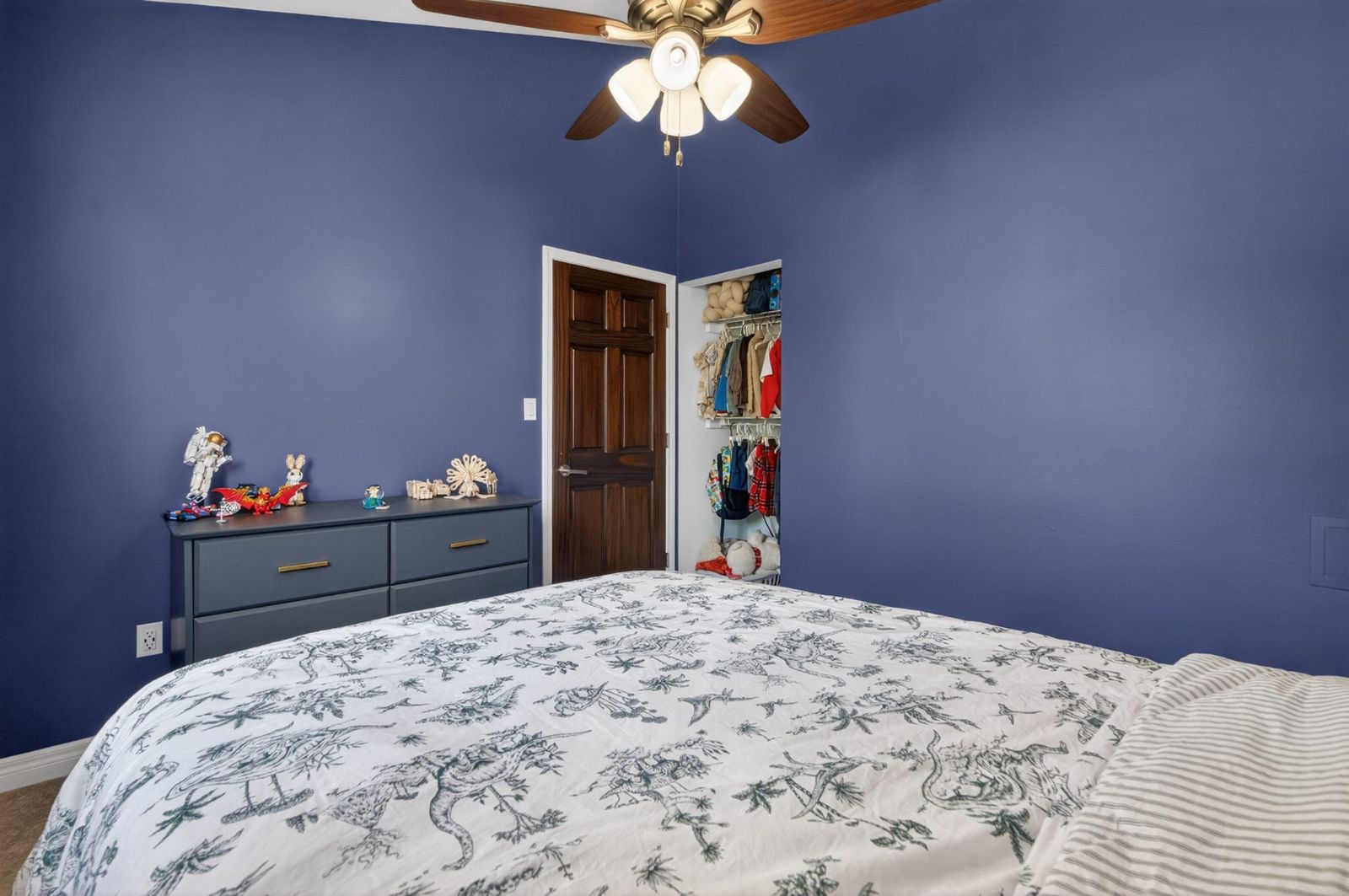 Bedroom with walk-in closet and ceiling fan