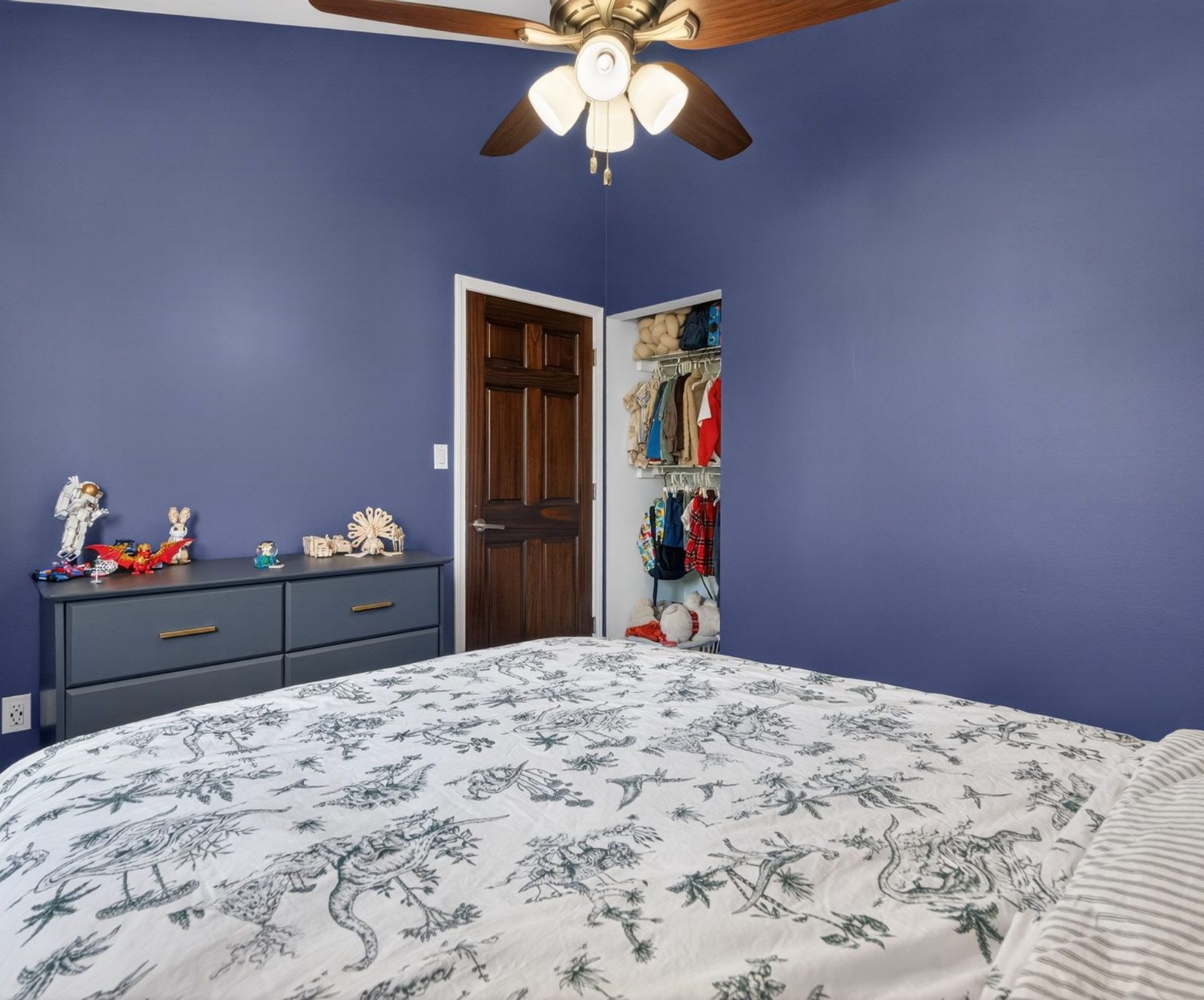 Bedroom with walk-in closet and ceiling fan