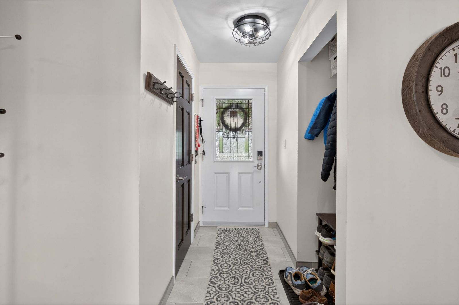 Entryway with patterned tile and coat closet