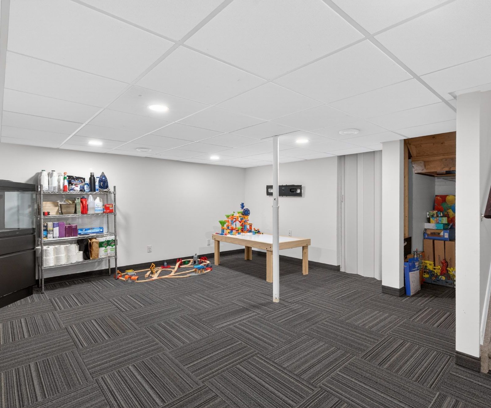 Finished basement with carpet and recessed lighting