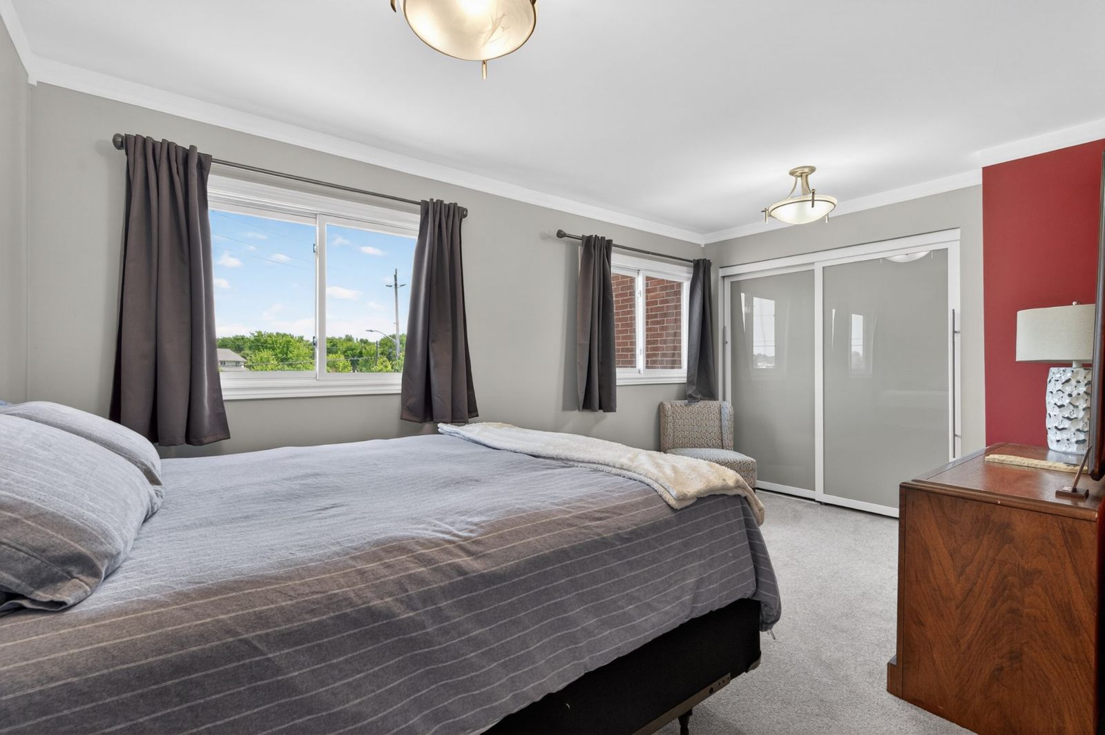 Primary bedroom with updated windows and closet
