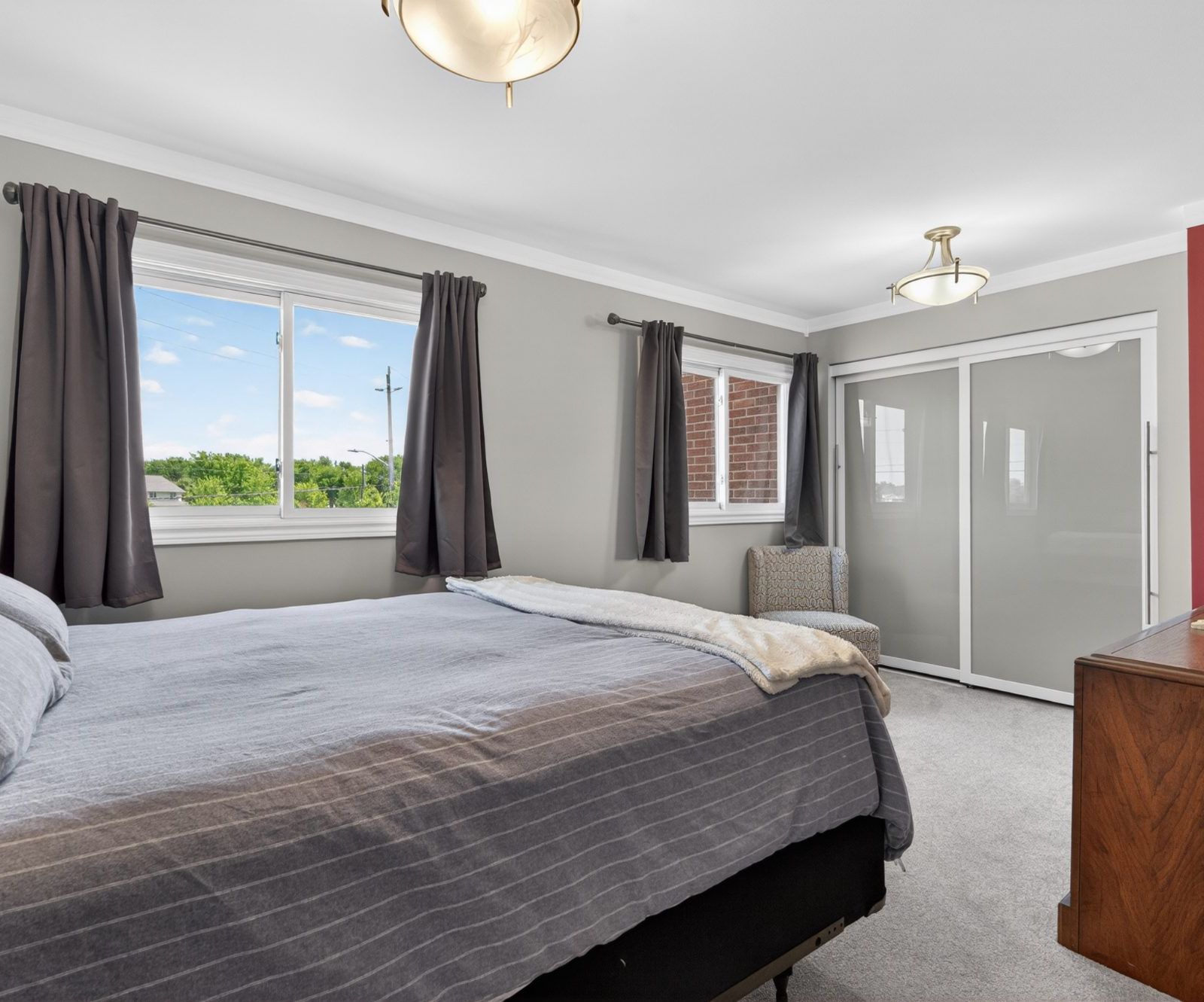 Primary bedroom with updated windows and closet