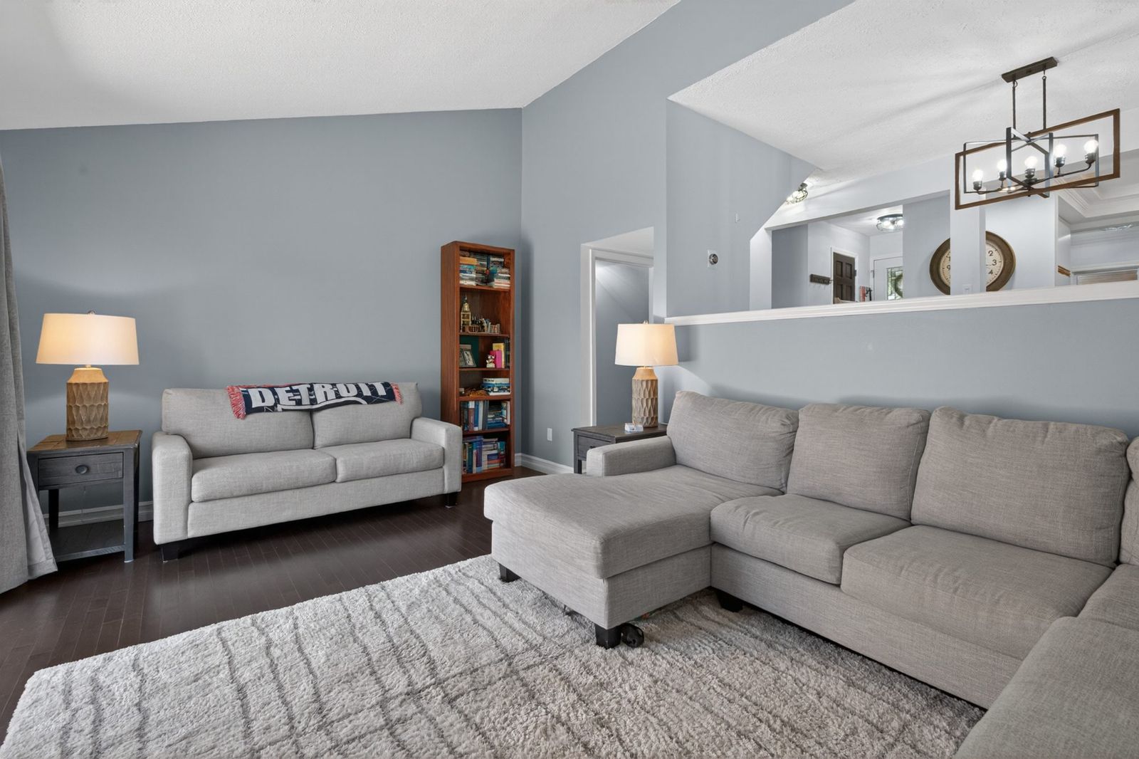 Living room showing high ceiling and half wall