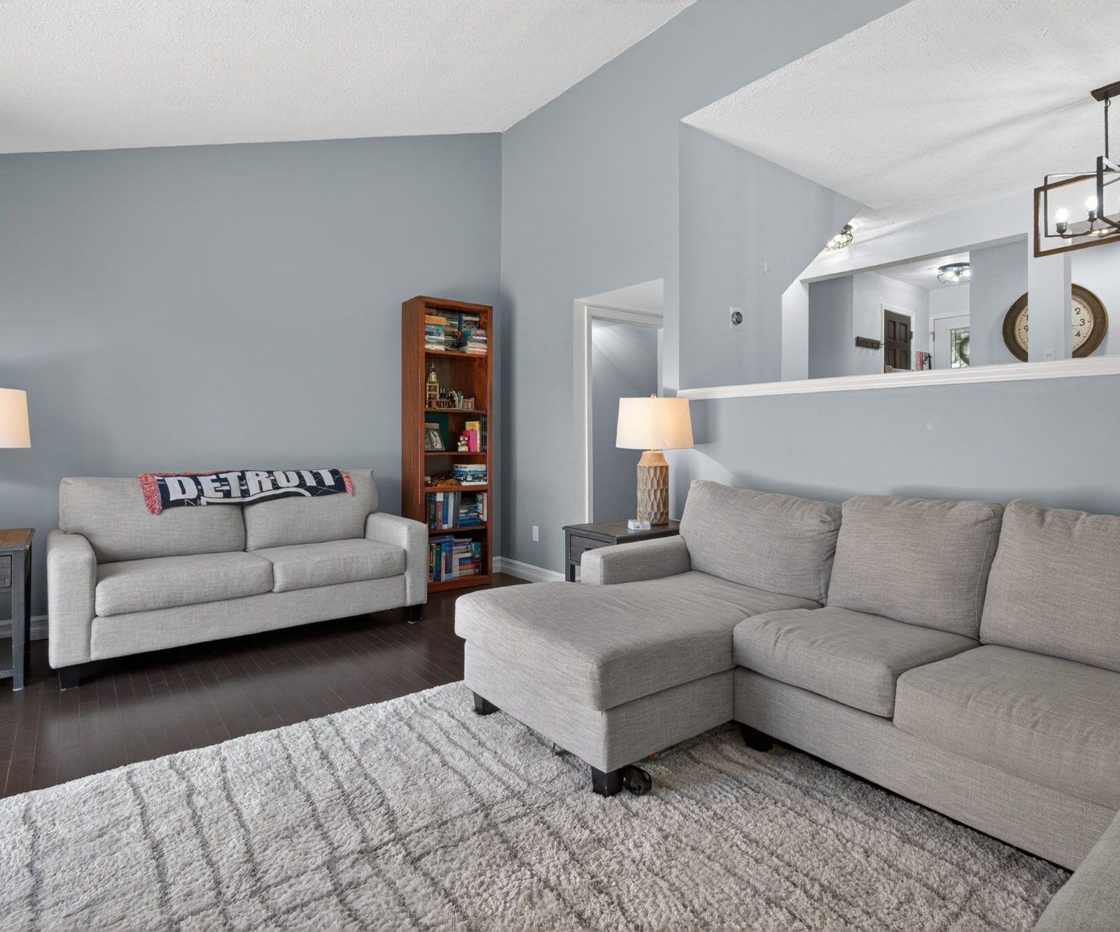 Living room showing high ceiling and half wall