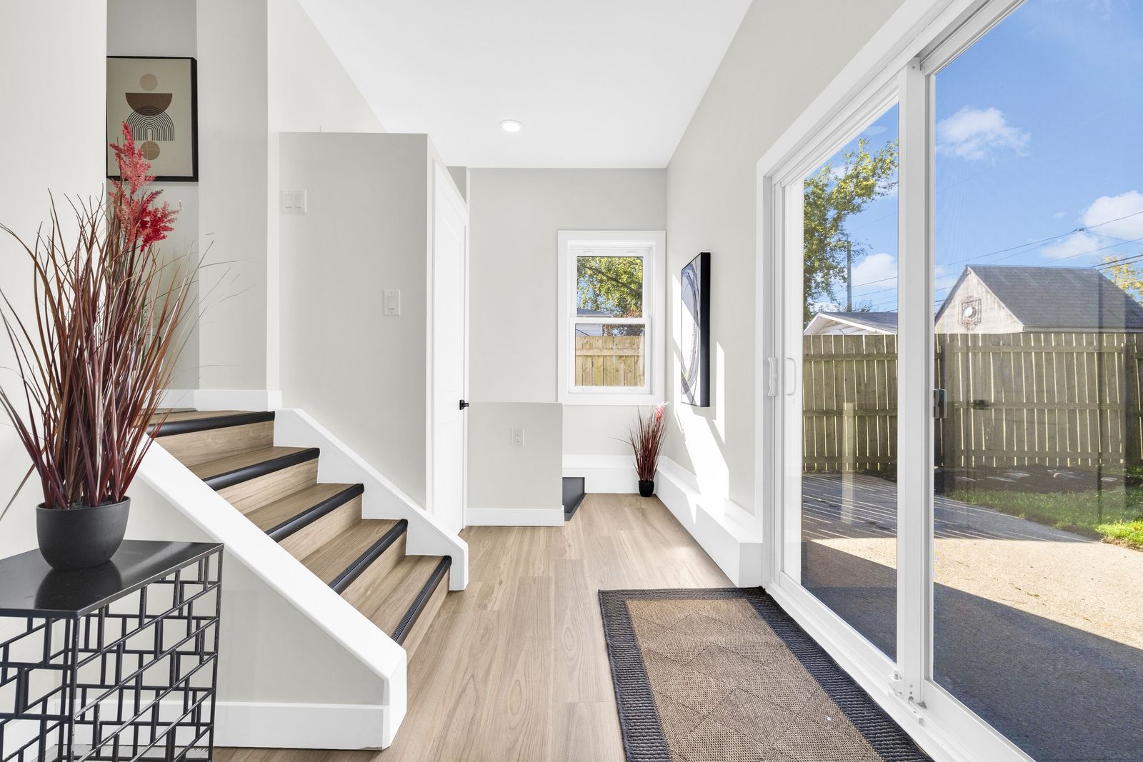 Back entry with a sliding glass door to the yard and steps up to the main floor.