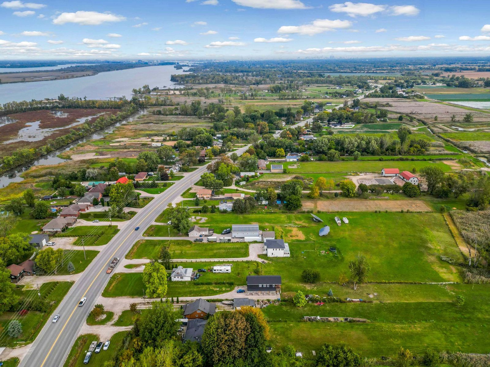 Aerial view of the road, houses, fields and the canal.
