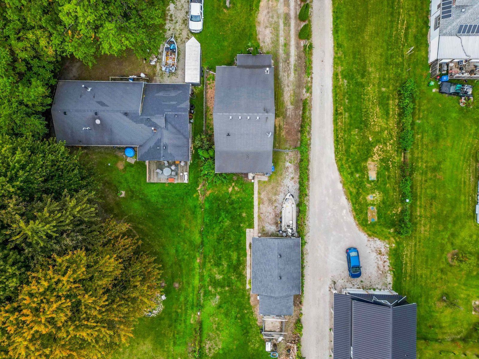 Top-down aerial view of the house, garage, yard and driveway.