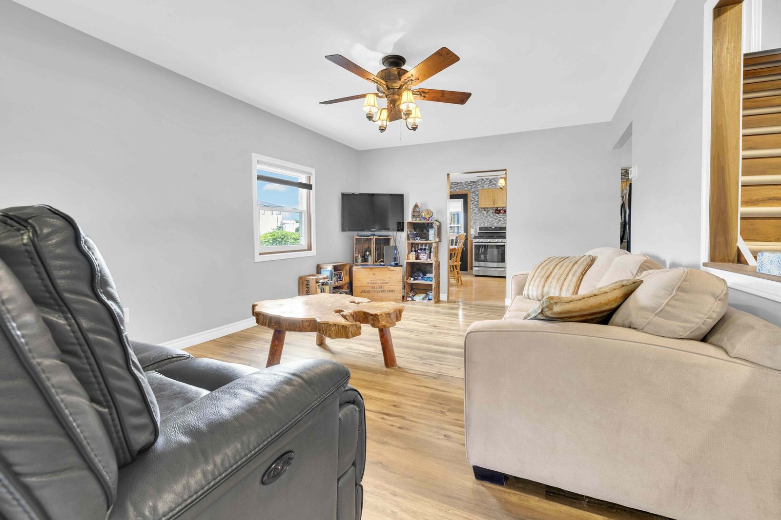 Living room with sofas, a recliner and a wooden coffee table.