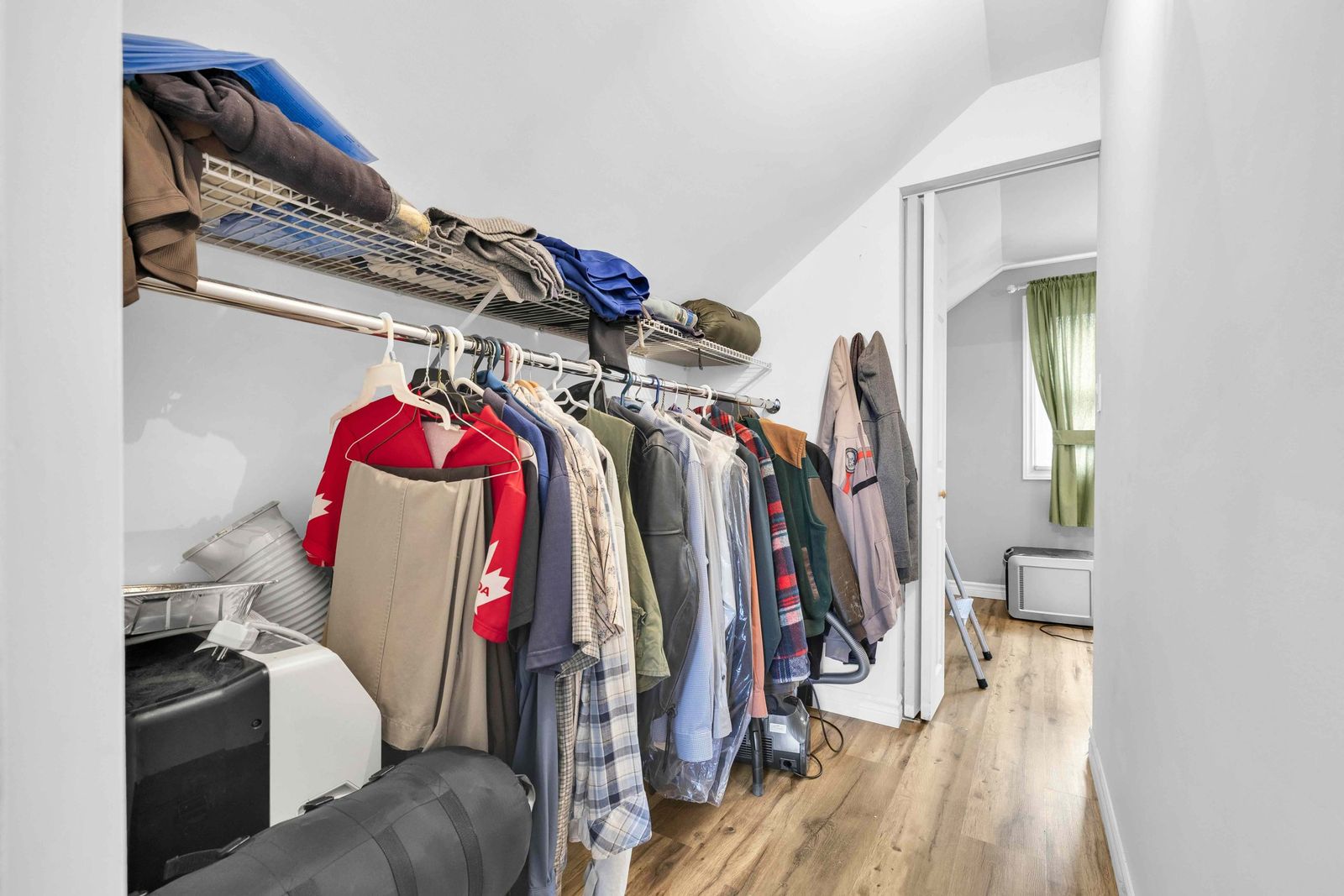 Closet with hanging rail and wire shelving.