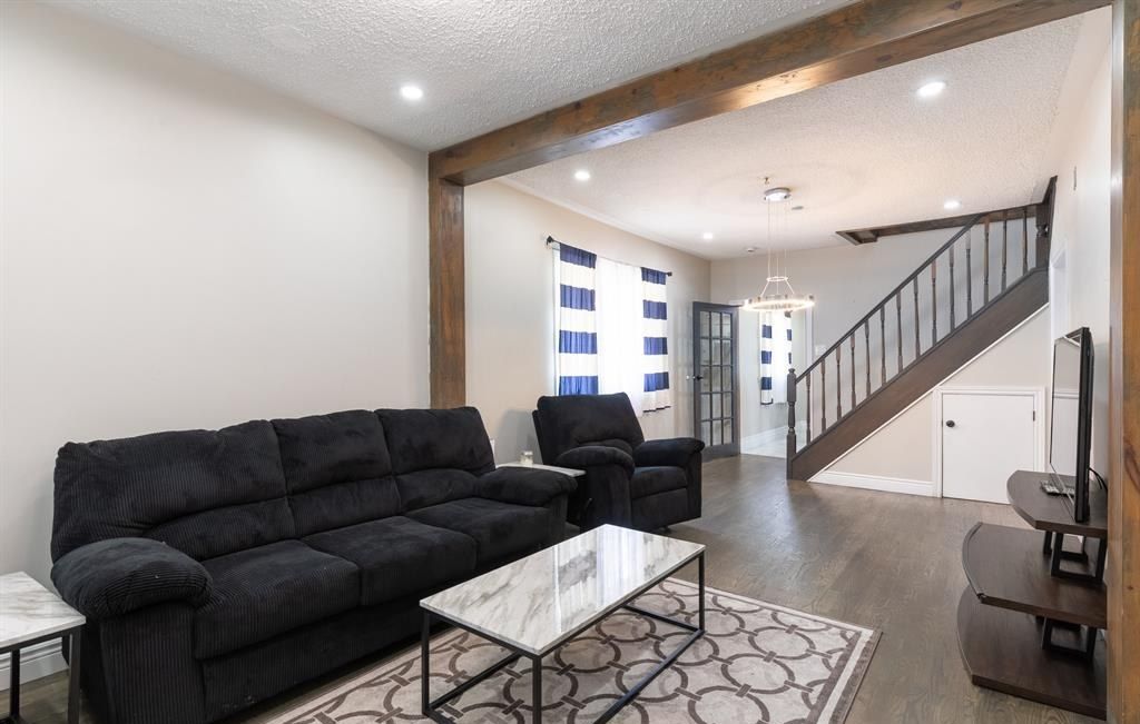 Living room with a sofa, a coffee table and a staircase.