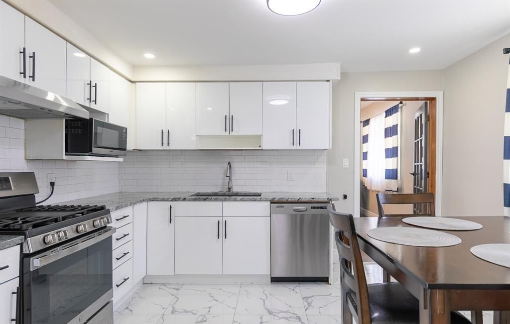 Kitchen with a range, a dishwasher and a sink.