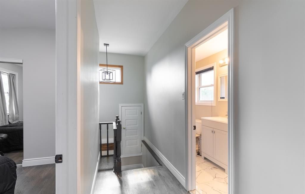 Hallway with doorways to several rooms.