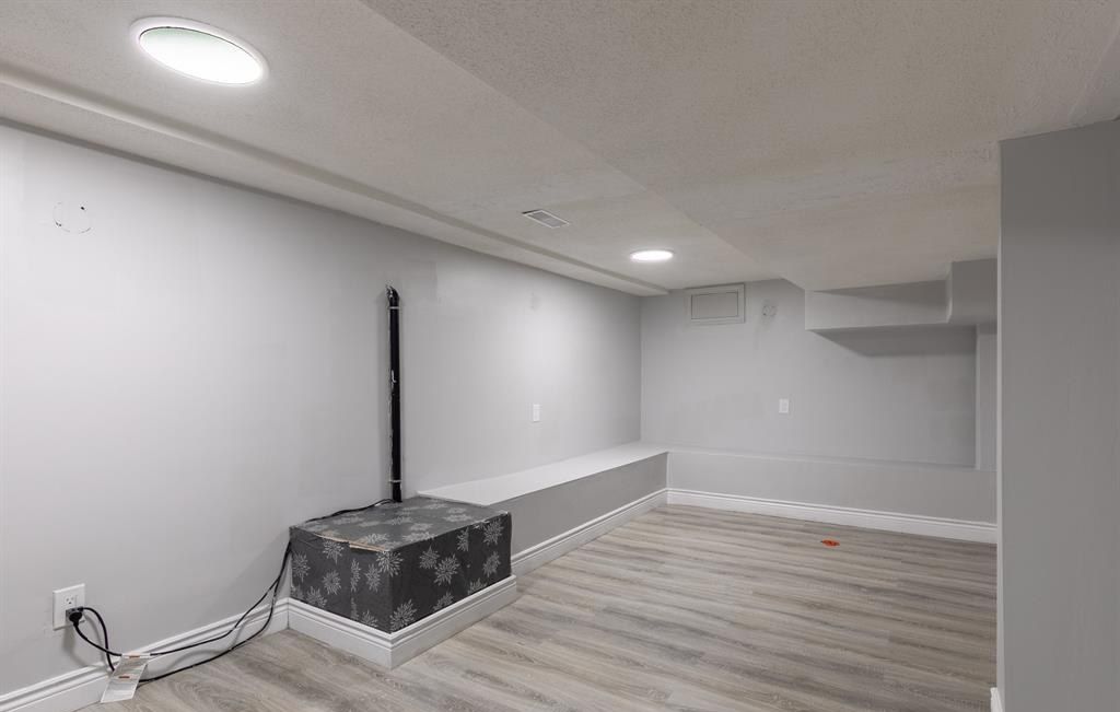 Empty room with a sump pump on the floor.